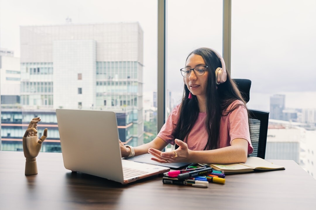 Person participating in an online video conference on laptop